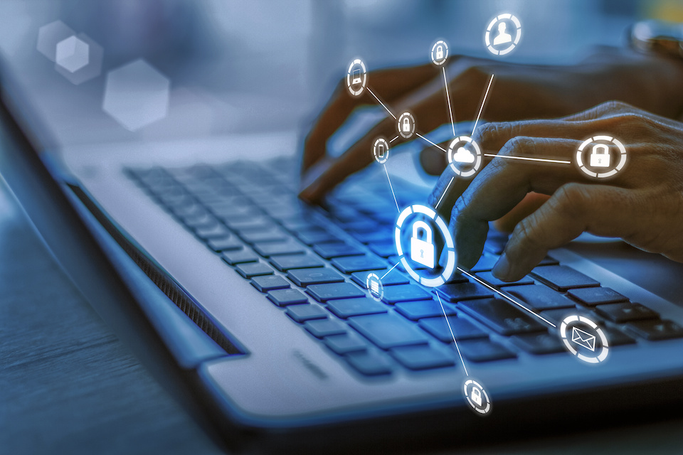 Business, technology, internet and networking concept. Young businesswoman working on his laptop in the office, select the icon security on the virtual display.Blue tone concept in Data Securty 2025